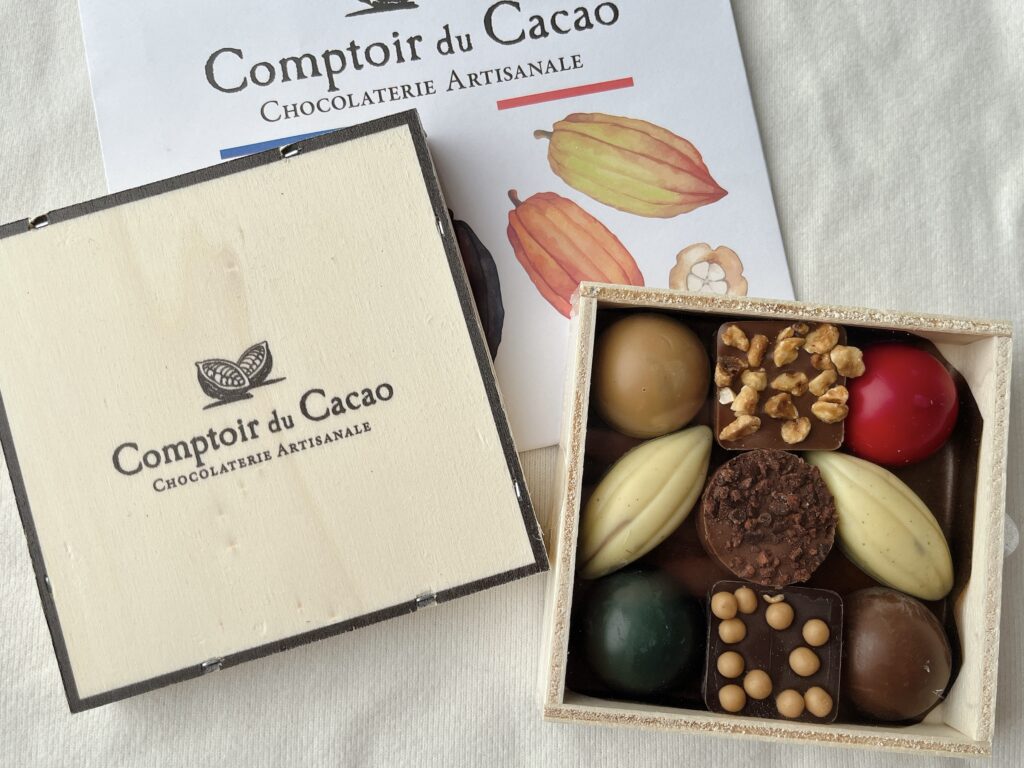 木箱に入ったチョコレートアソート。赤、深緑、白、茶色と色とりどり。