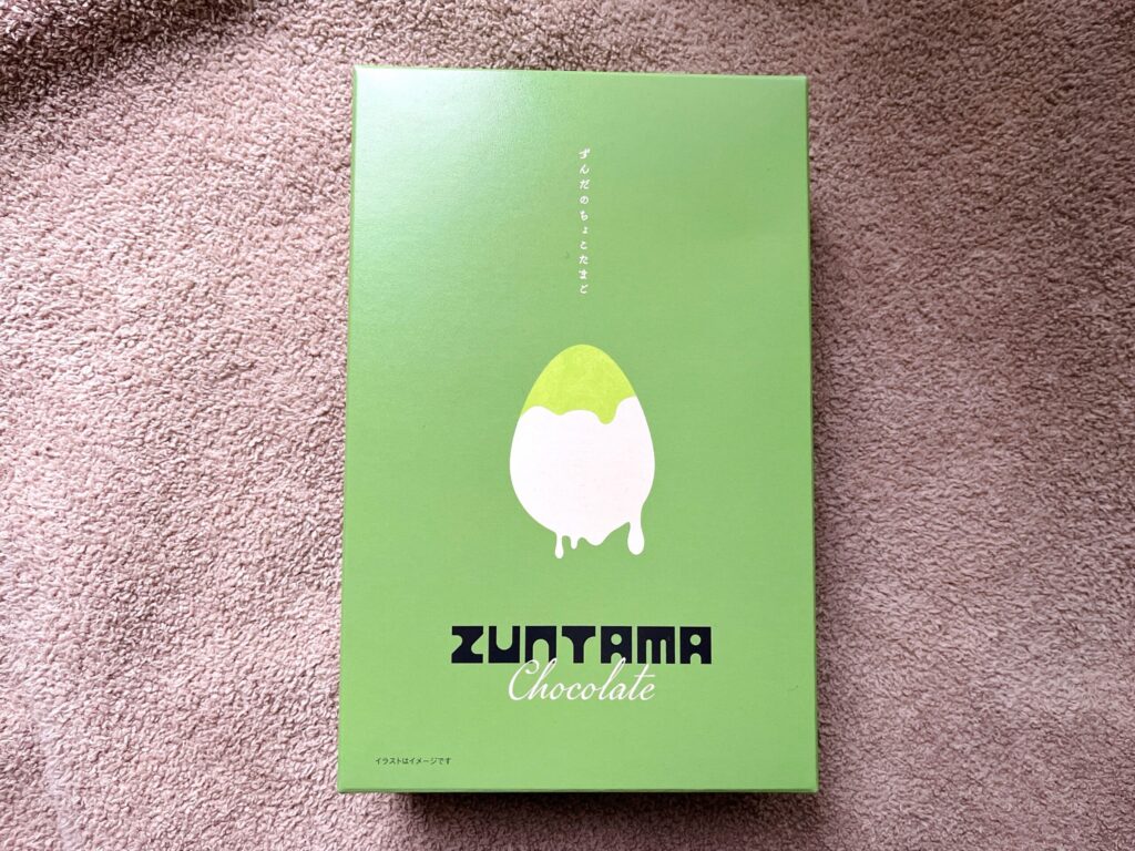 黄緑色の背景に白いたまごの形のイラストが描かれたシンプルな外箱